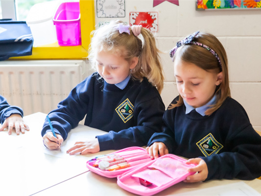 Children in the school with pink pencil case